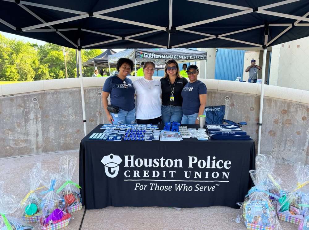 Diverse group of Houston Police Credit Union workers volunteering at a Easter event