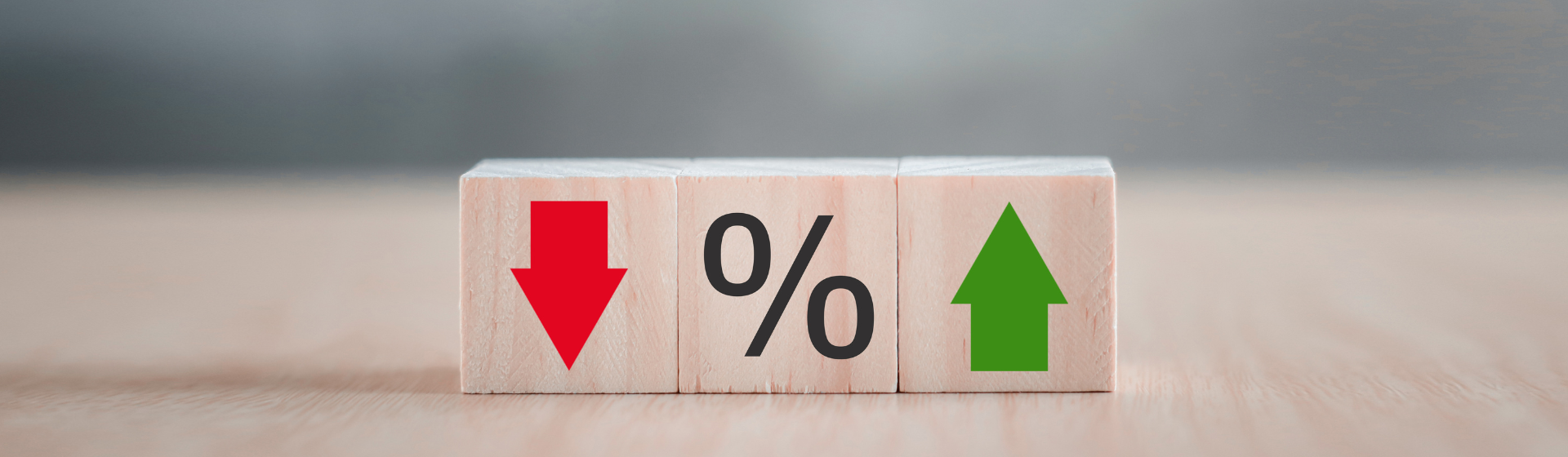 Cubes with down arrow percentage sign and up arrow in reference to deposit & loan rates