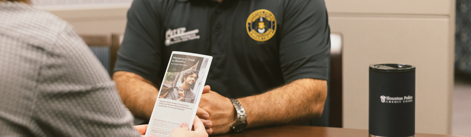 Member service representative explaining brochure to a Houston Police Officer member