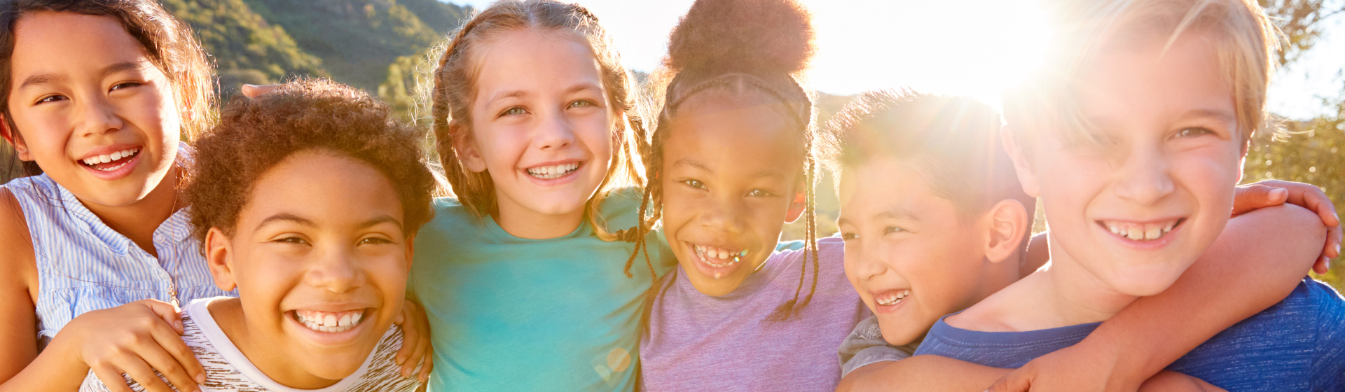 Portrait Of Multi-Cultural Children Hanging Out With Friends In Countryside Together