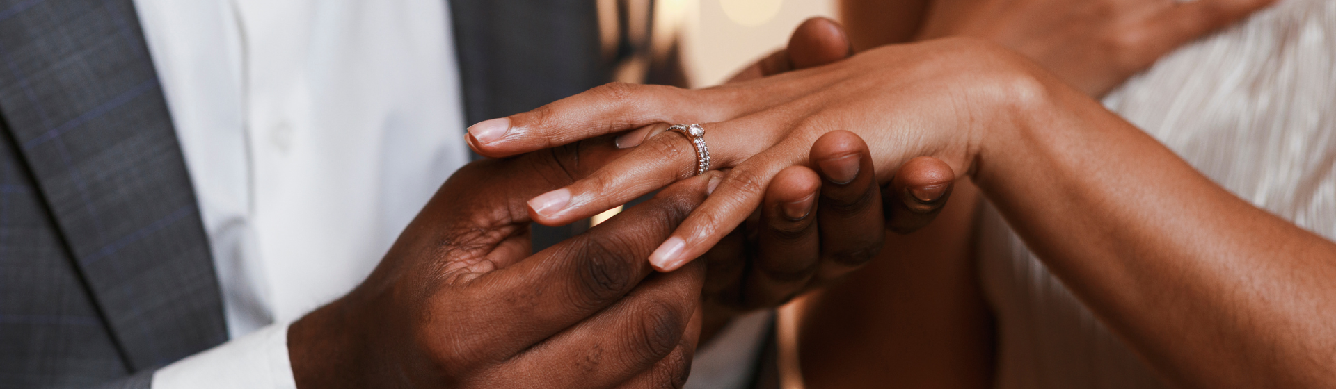 Close up of african man putting ring on his fiance